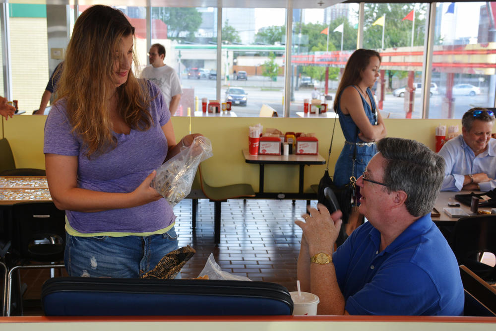 Elena Perrotta (left) discussing pins with Scott Reed (right) of the Atlanta Pin Collectors.