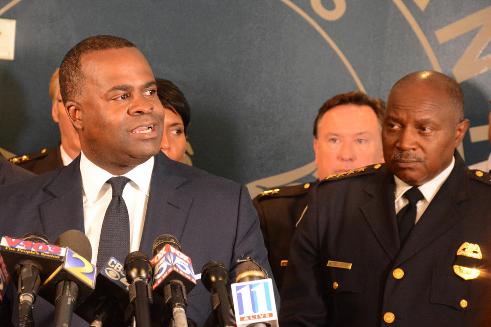 Atlanta Mayor Kasim Reed discusses his decision to involve the FBI in the APD's investigation as Chief George Turner looks on.