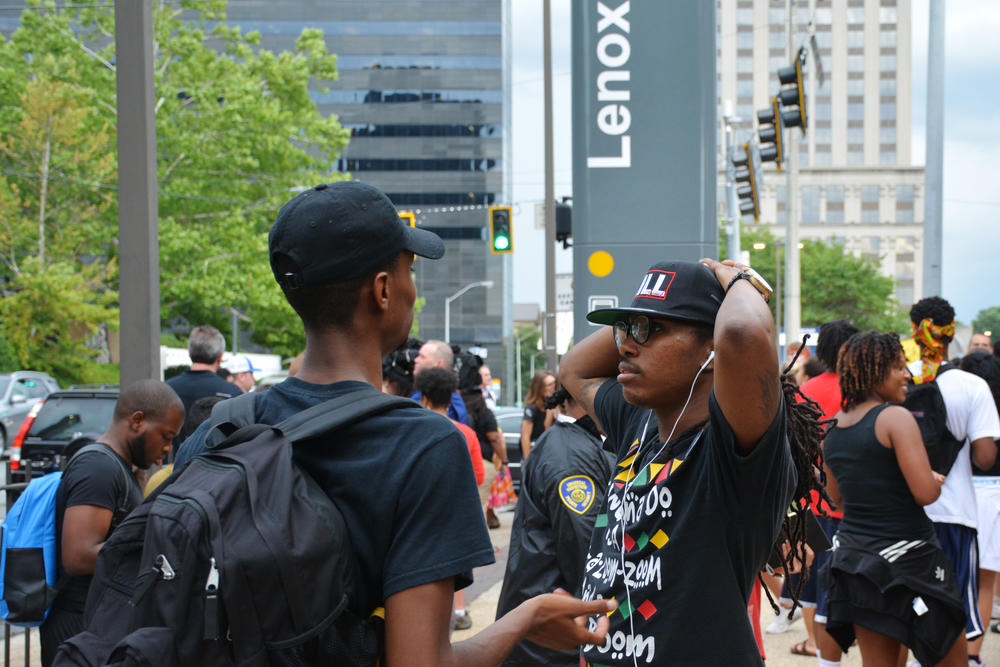 Seyoum Bey (right) discussing strategy with another protester in advance of Monday's demonstration.