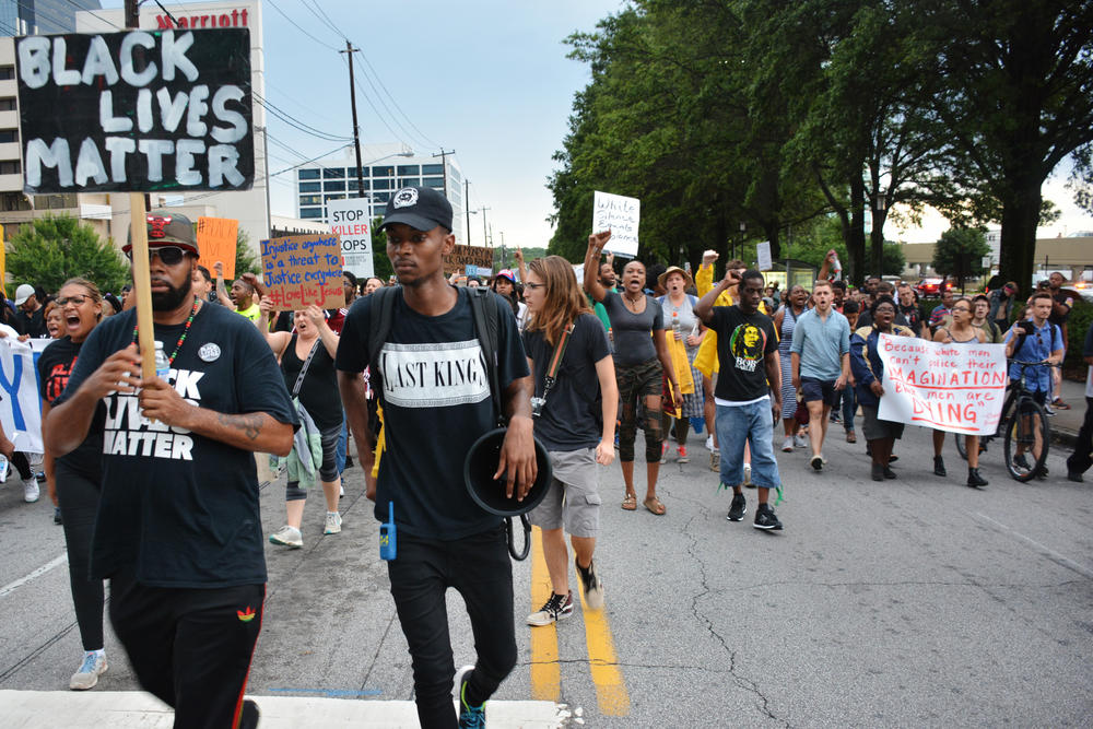 Protesters marching up Lenox Road in Atlanta's Buckhead neighborhood Monday.