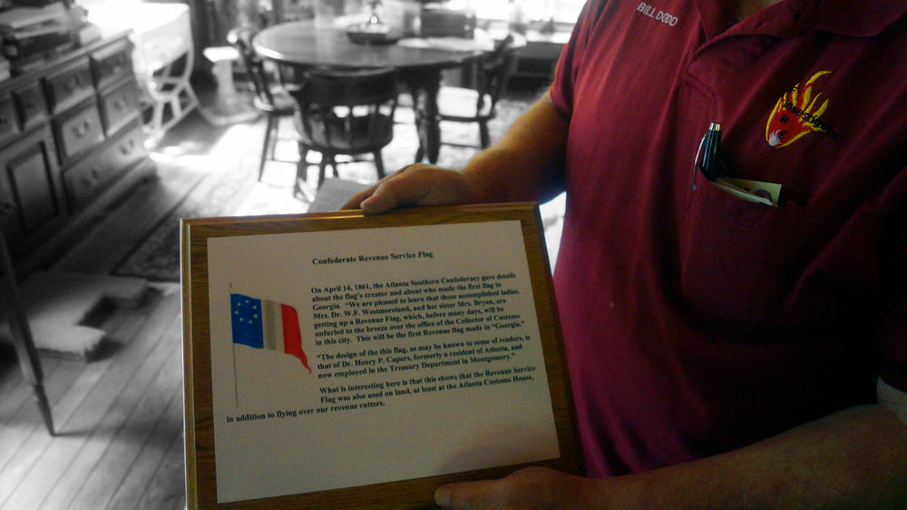 Bill Dodd, curator of the now-defunct Nash Farm Battlefield Museum, holds one of the display items in his home.