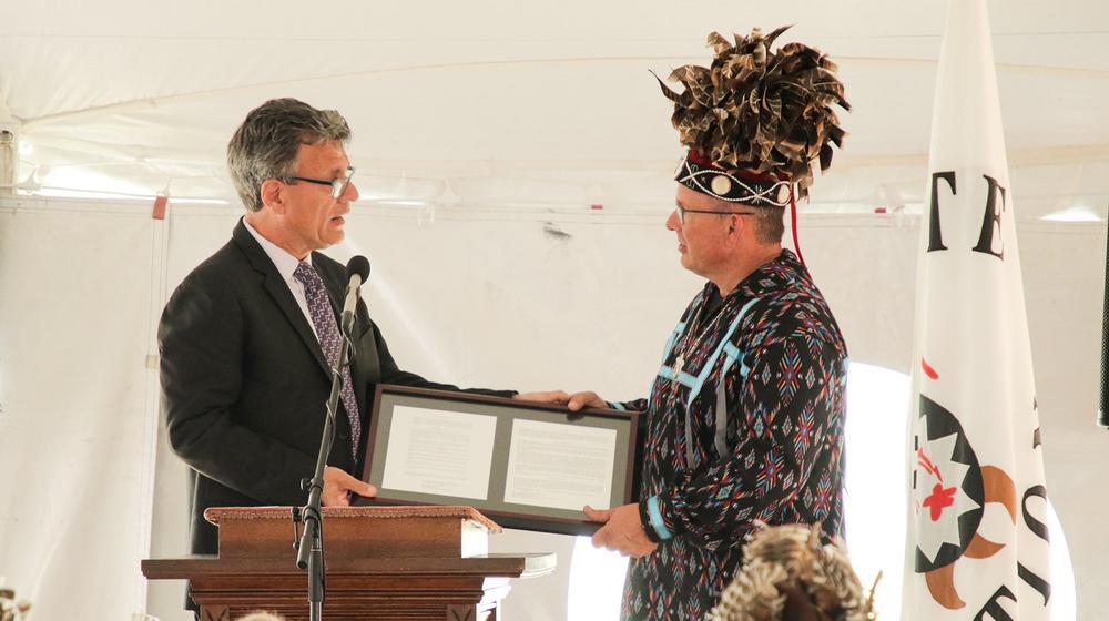 General Secretary of the United Methodist Church Global Ministries Thomas Kemper hands Wyandotte Nation Chief Billy Friend the deed to 3 acres of land in Upper Sandusky, Ohio.