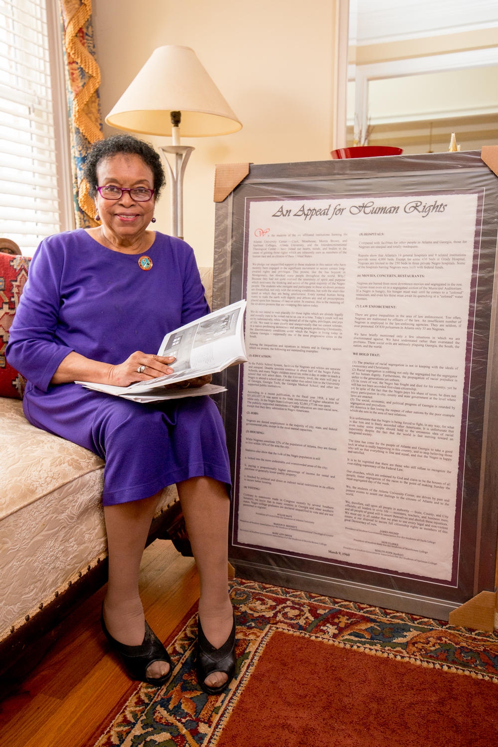 Dr. Roslyn Pope in her home next to her framed 