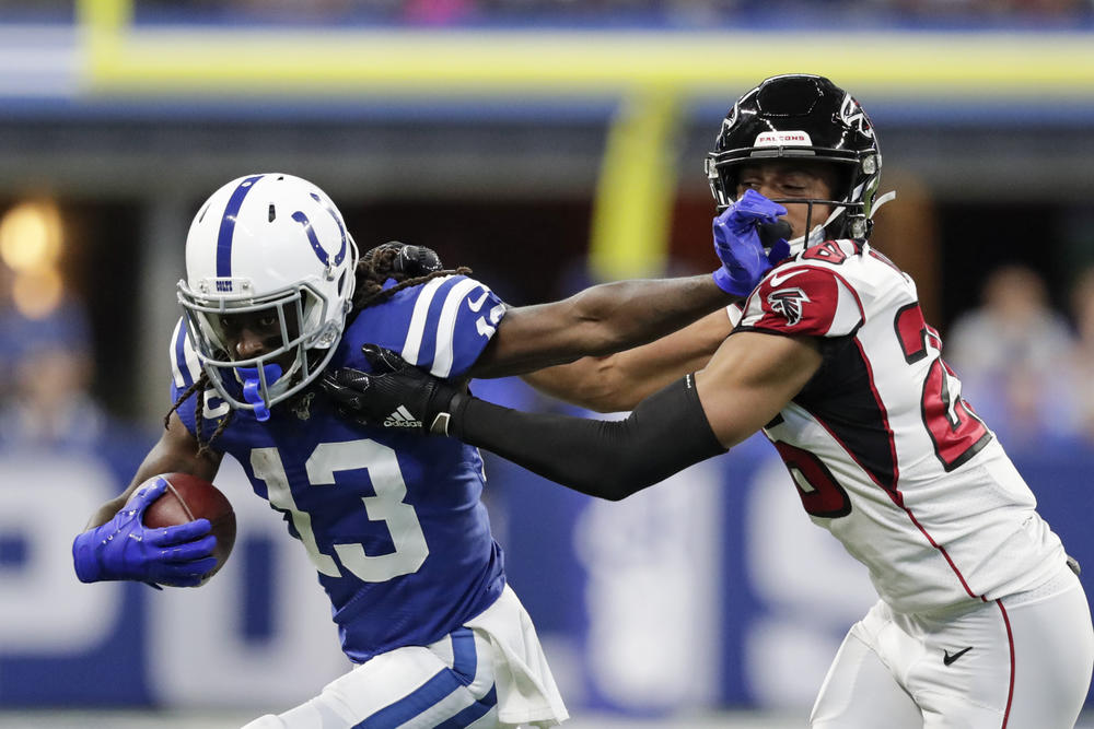 Indianapolis Colts wide receiver T.Y. Hilton (13) is tackled by Atlanta Falcons cornerback Isaiah Oliver (26) during the first half of an NFL football game, Sunday, Sept. 22, 2019, in Indianapolis. 