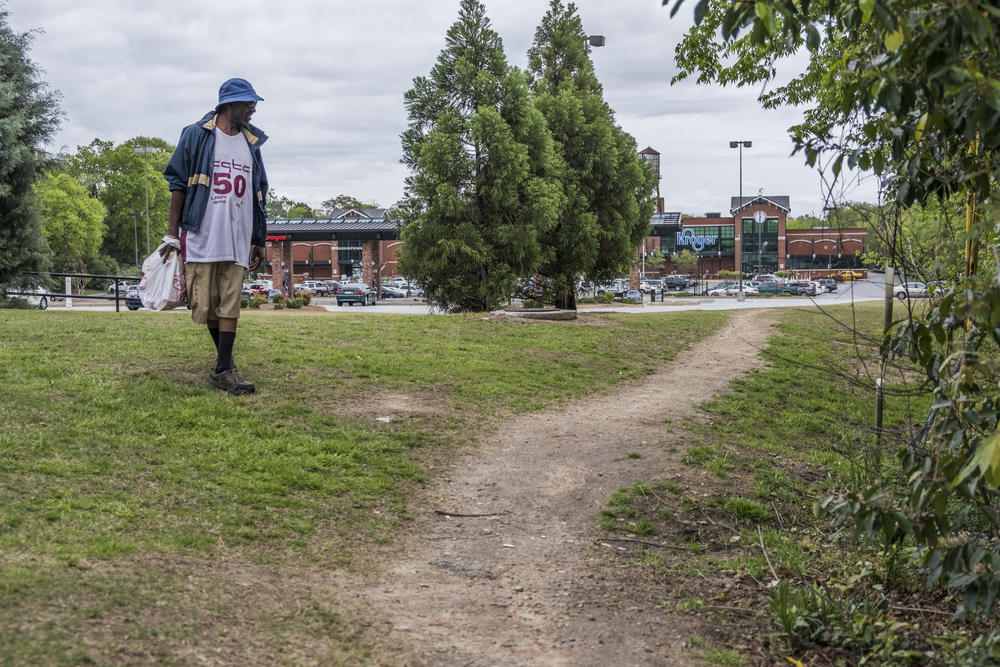 Roger Williams carries a bag of groceries away from the now closed Kroger store on Pio Nono Avenue in Macon. The neighborhood around the store has been a food desert based on transportation issues since 2010. How will Williams get food now? "It's something I'll have to think about now that I don't have a car," he said. 