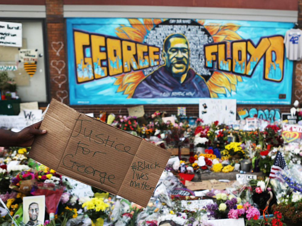 People gather at the site where George Floyd was killed while in the custody of the Minneapolis Police Department.