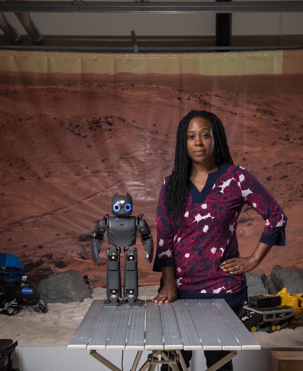 Dr. Howard with Darwin, a robotic assistant that helps children with disabilities accomplish physical therapy at home.