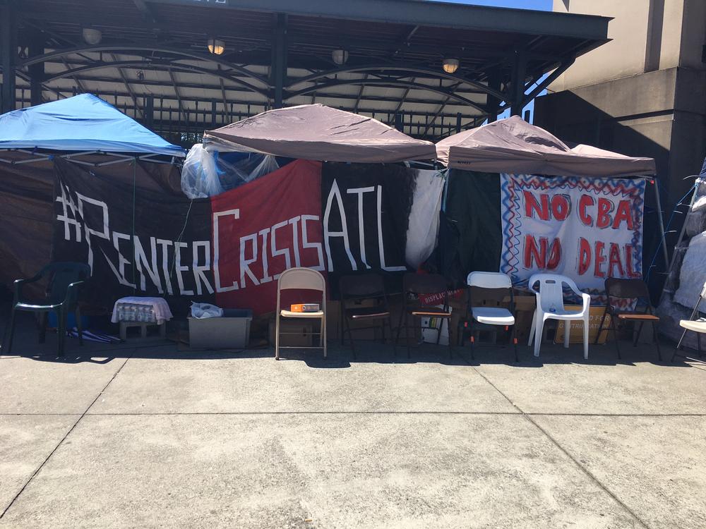 A sign stretches across a few tents at the 