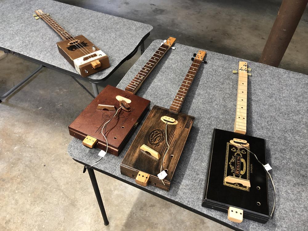 Some of the cigar box guitars Mike Snowden builds in his Marietta home.