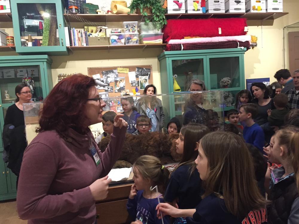 Whitney Thompson talks to a tour group about the levers, pulleys and machines that make up complicated puppets.