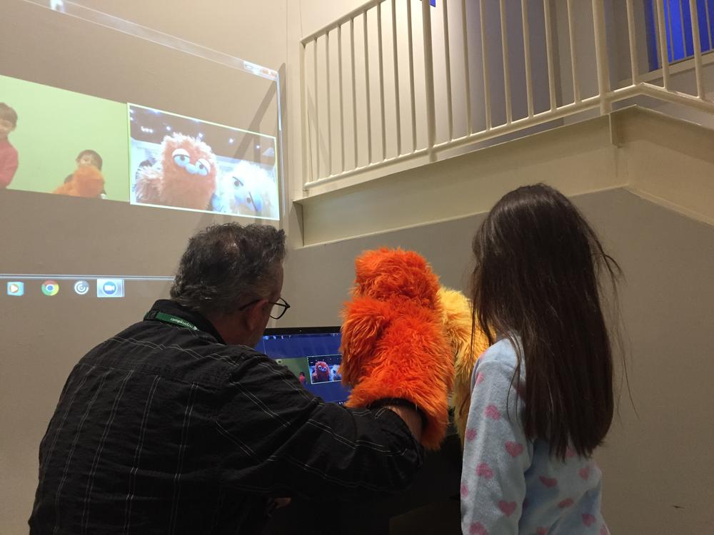 The orange puppet's name is Satsuma. He's one of the characters that used to show students how arts and science come together.