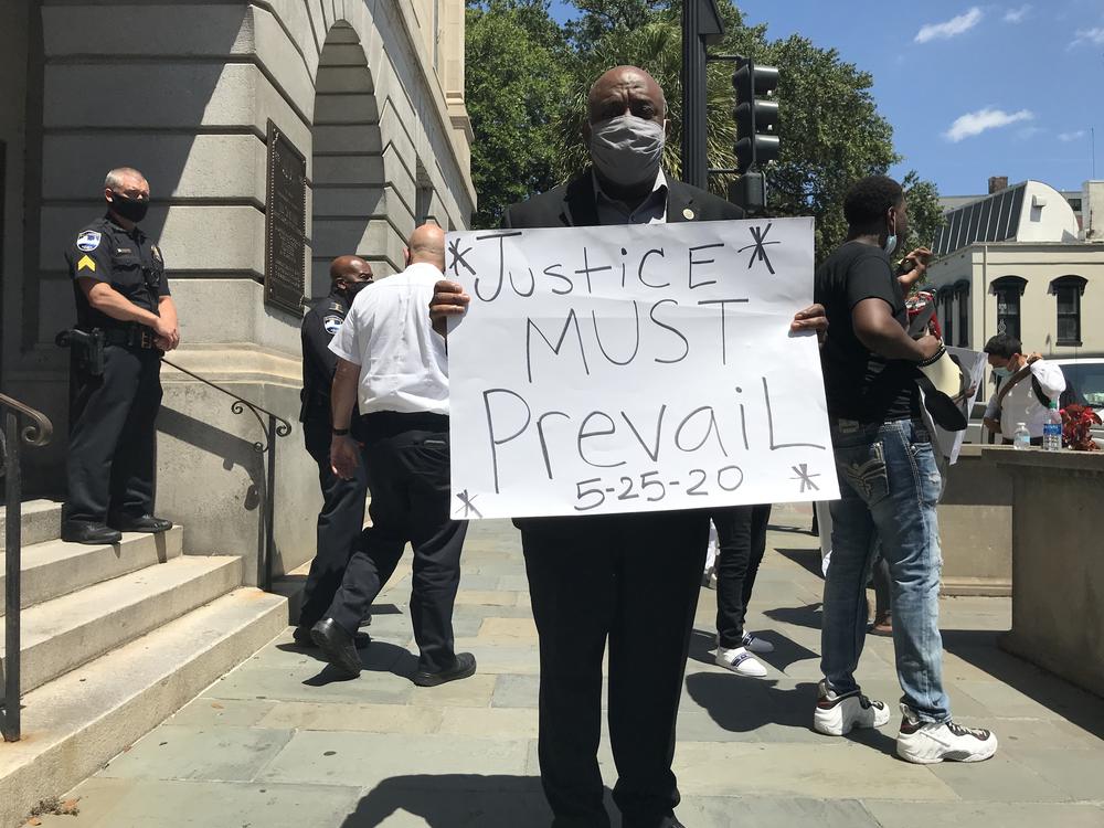 Mayor Van Johnson holds a sign that reads "Justice must prevail" as part of Savannah's demonstrations after the death of George Floyd, in May 2020.