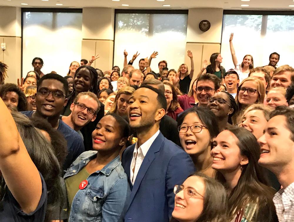 Singer-songwriter John Legend poses for a group photo with students at a Stacey Abrams campaign event.