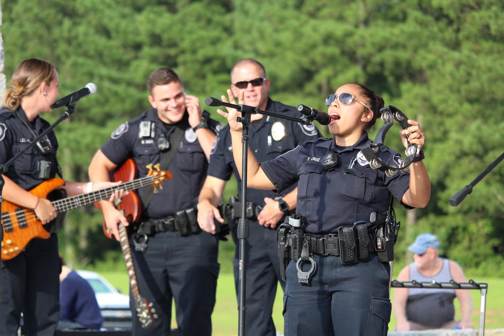 Canton Police Chief Mark Mitchell (second from left) and officers host a lip sync challenge concert Thursday July 26 in Etowah River Park.