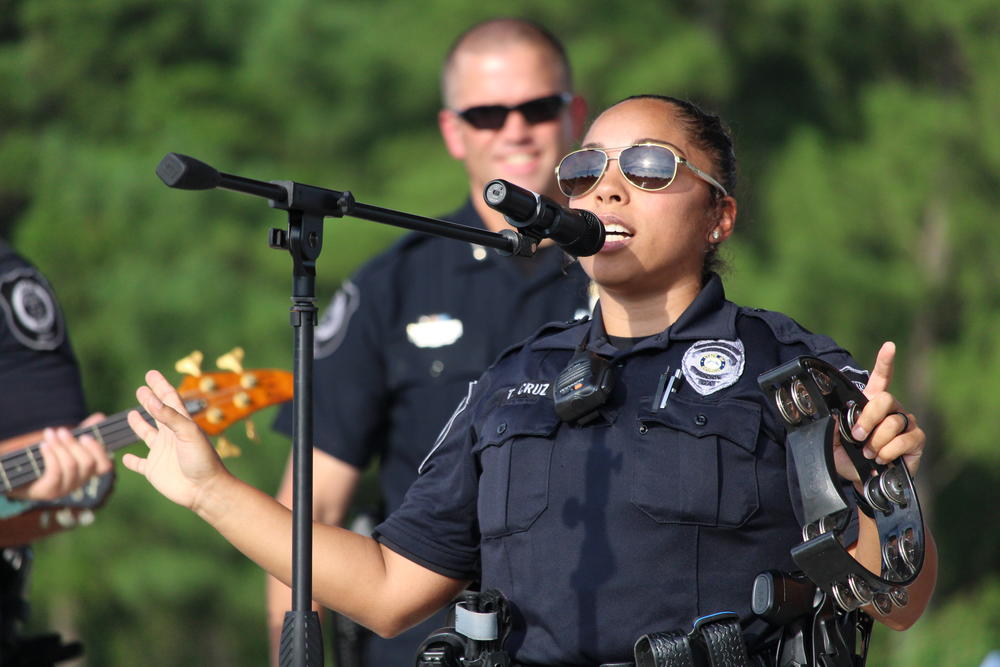 Officer T. Cruz takes the mic to announce how the community can participate in the Canton police lip sync challenge Thursday July 26 in Etowah River Park.