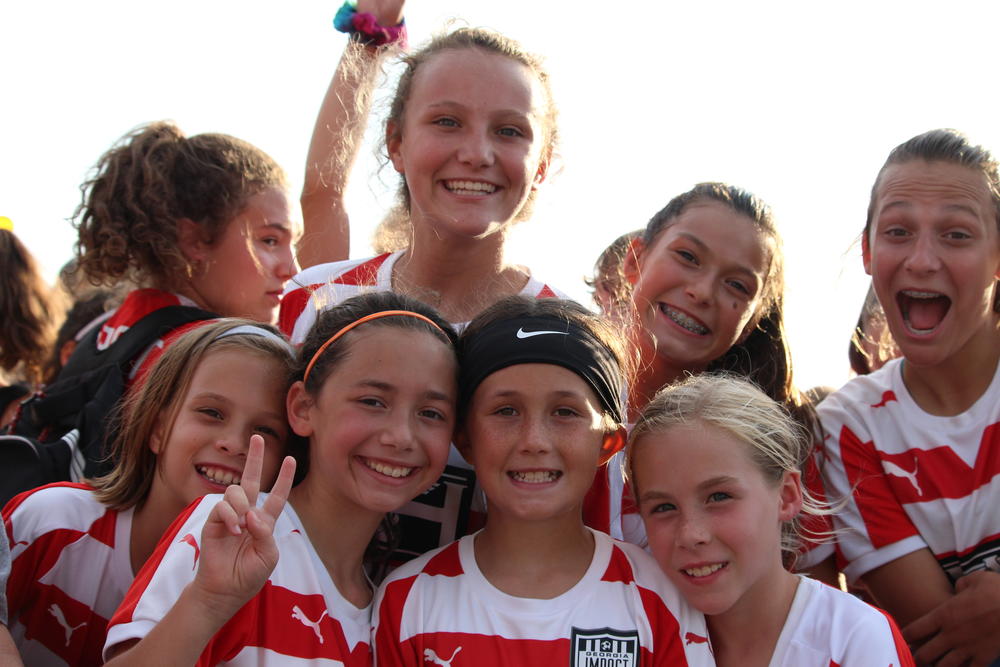 Georgia Impact soccer players smile from the stands for the Canton police lip sync challenge video shoot Thursday July 26 in Etowah River Park.