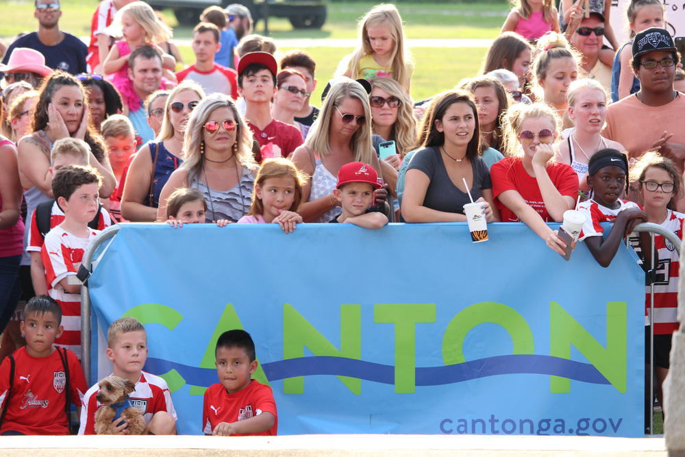 Community members eagerly await the four songs Canton police chose for their lip sync challenge Thursday July 26 in Etowah River Park.