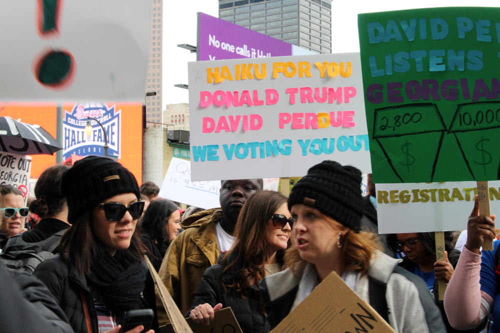 A crowd of about 250 protestors gathered in Centennial Olympic Park outside the Georgia World Congress Center Friday Nov. 8, 2019.
