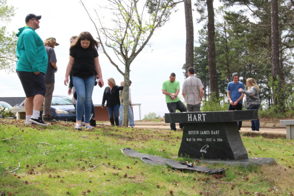 Friends and family gather with Heather Wysocki at the grave of her sons Dustin Hart and Austin Hart on Saturday, March 14, 2020.