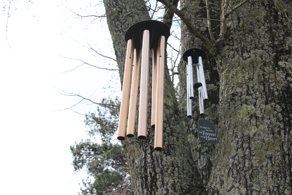 Wind chimes hung on a tree near the grave of Dustin Hart and Austin Hart. 