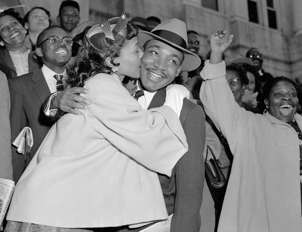 The Rev. Martin Luther King Jr. is welcomed with a kiss by his wife Coretta after leaving court in Montgomery, Ala., March 22, 1956.