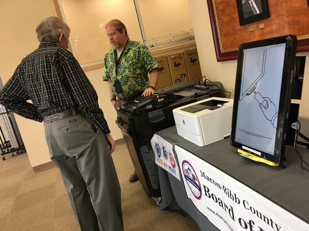 Macon-Bibb County elections officer Thomas Gillon demonstrates the new voting machines Thursday at the board of elections office on Pio Nono Avenue.