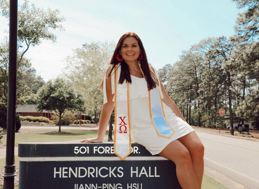 McKenzie Artman, a 2020 graduate of Georgia Southern University poses in front of Hendricks Hall on campus.