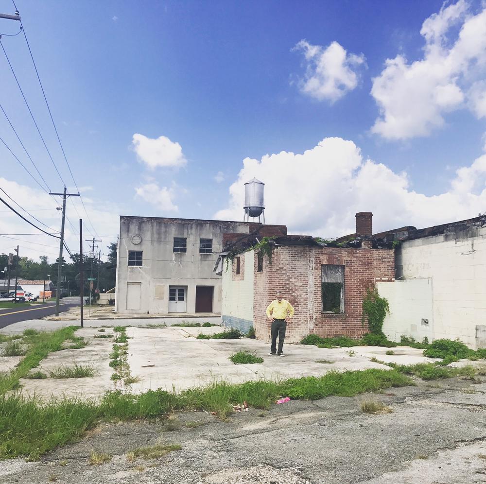 GPB's Don Smith walks around in front of the former Star Theatre on Quitman's South side. 