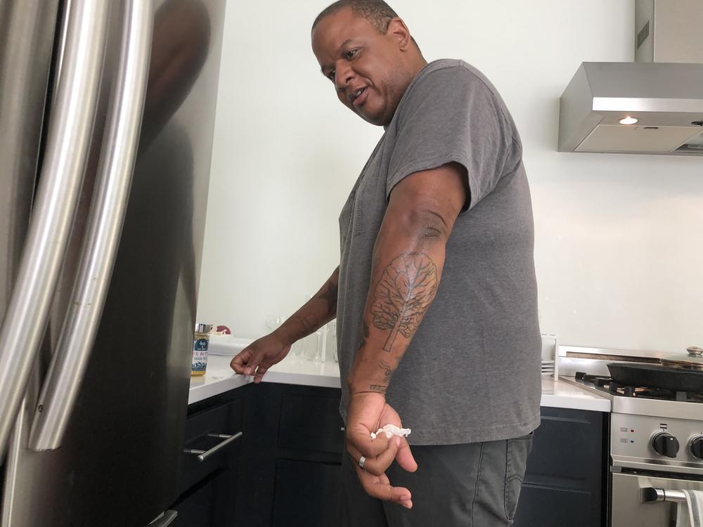 Todd Richards shows off his collard green tattoo.