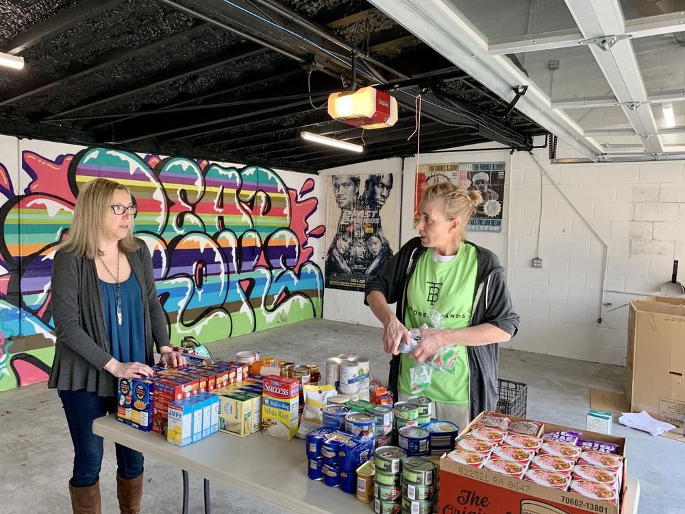 Volunteers with Neighbor In Need East Lake collect food to distribute to senior citizens who are urged to stay in their home to avoid contracting the coronavirus.