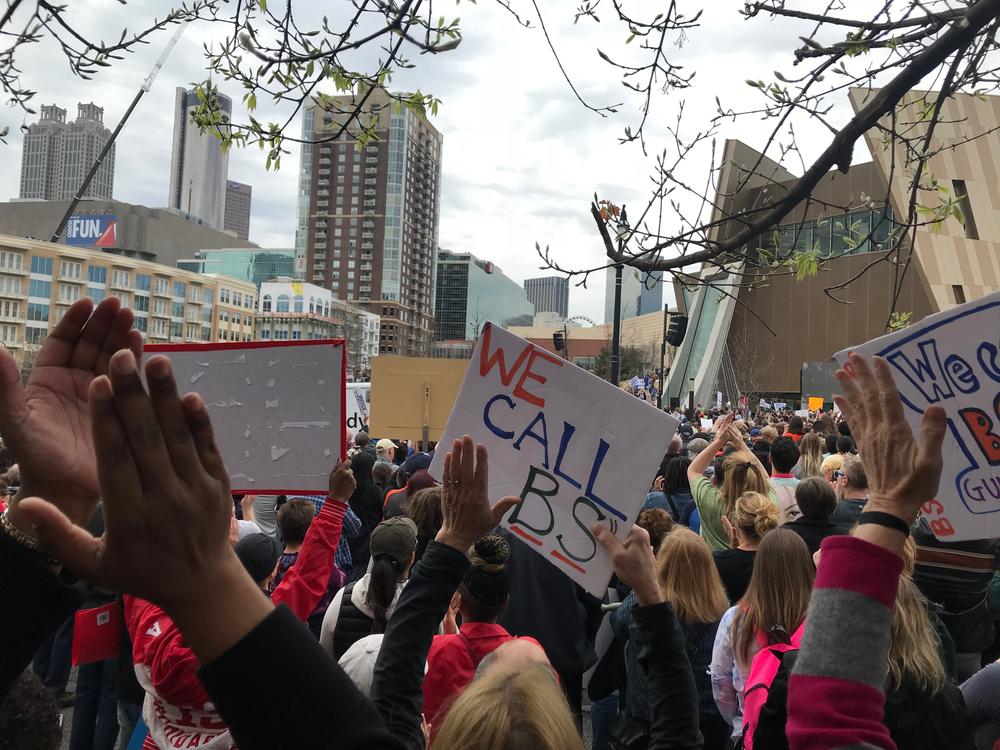 The crowd applauds Representative John Lewis' speech.