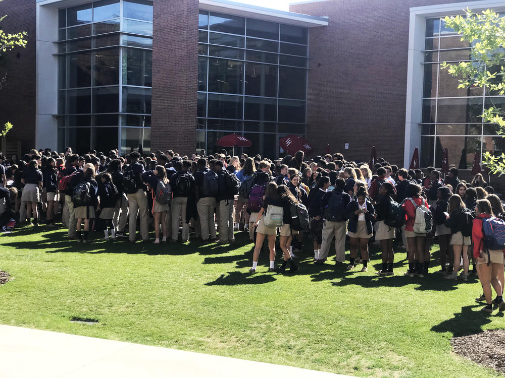 Students walk out of Woodward Academy in College Park. 