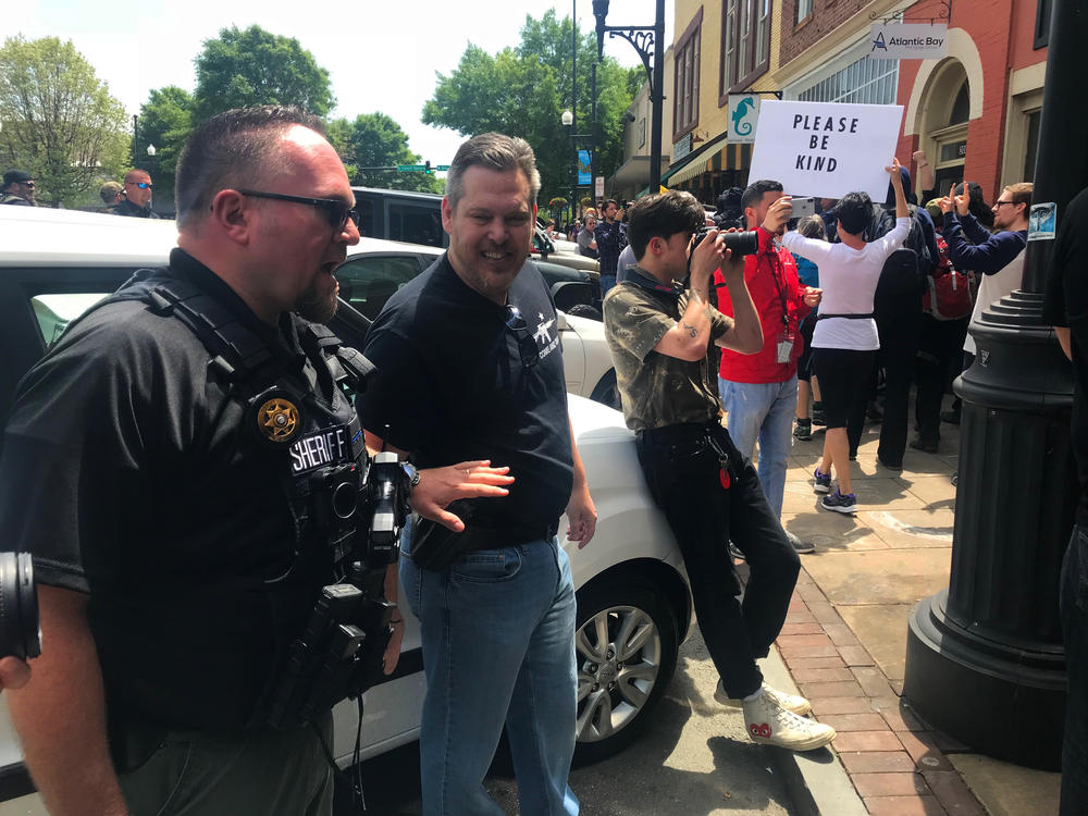 A deputy tells a man to stand down as he taunts Atlanta Antifa counter protestors in a tense march down Newnan's main drag. 