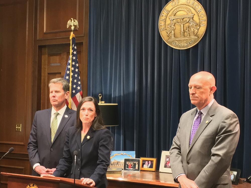 Jaret Usher will lead the state's new anti-gang task force at the Georgia Bureau of Investigation. Also present are Gov. Brian Kemp (left) and GBI Director Vic Reynolds (right).