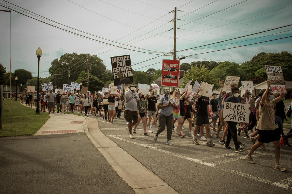 Protesters march in Kennesaw on Sunday.