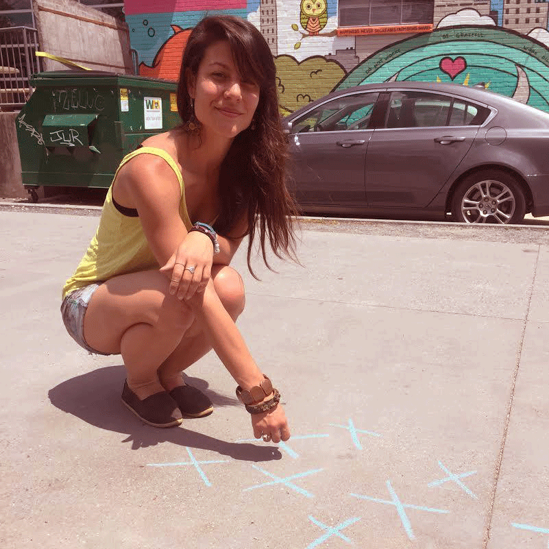 Atlanta artist Jessica Caldas, 29, marks an X on the BeltLine in Atlanta. She does this every 107 seconds to show the frequency of sexual abuse.