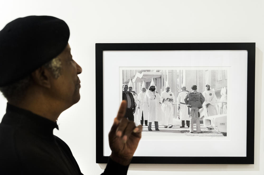 Jim Alexander with an image of an Ku Klux Klan protester facing down Klan members during a rally in Tupelo, Miss. in 1978. This image and others were used to prosecute Klan members who assaulted protesters. 
