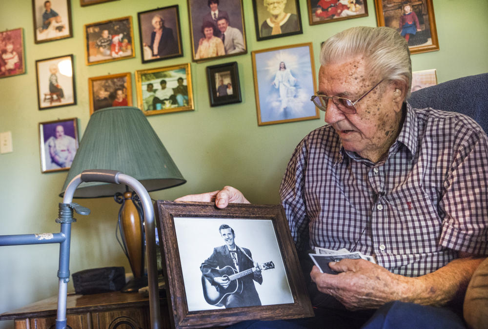 In the living room of his Macon, Ga. home, Jimmy Haney holds a photo of himself taken in the days when he played the Grand Ole Opry. Haney was once rhythm guitarist for Patsy Cline.
