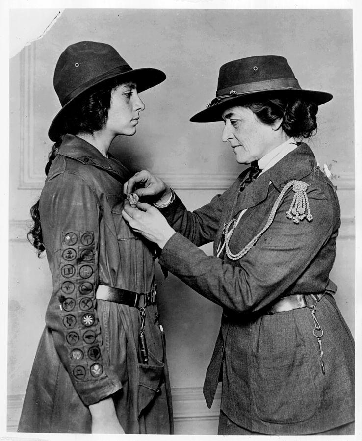 Juliette Gordon Low officiates a Girl Scout.