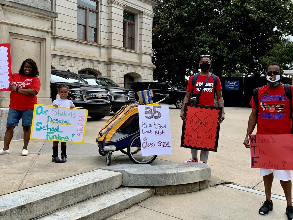 Teacher Justin T. Johnson (second from right) came to the Capitol Wednesday to talk with legislators about possible cuts.