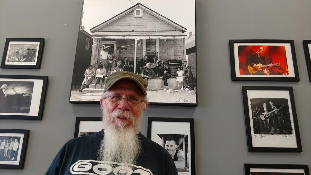 Kirk West, former Allman Brothers Band tour manager, stands in front of photographs he took of the group. West's documentary looks at the band's time at The Big House in Macon.