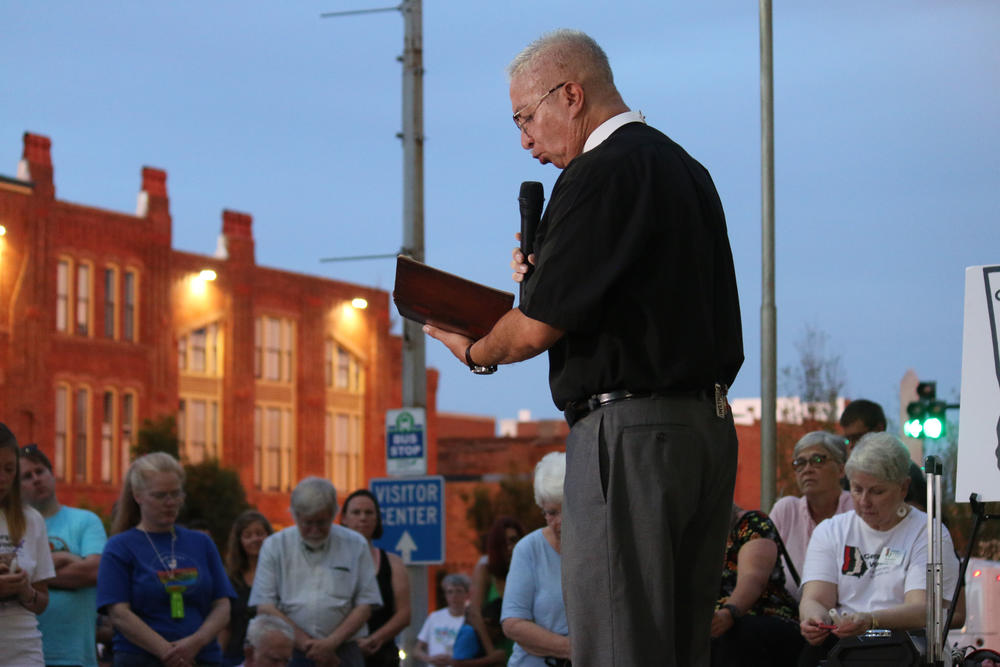 Pastor Daniel Medina reads from the Bible in Spanish and English. 