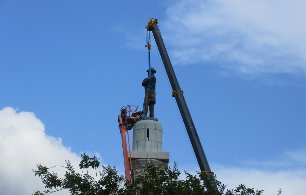 In this May 19, 2017 photo, workers prepare to take down the statue of former Confederate general Robert E. Lee in New Orleans.