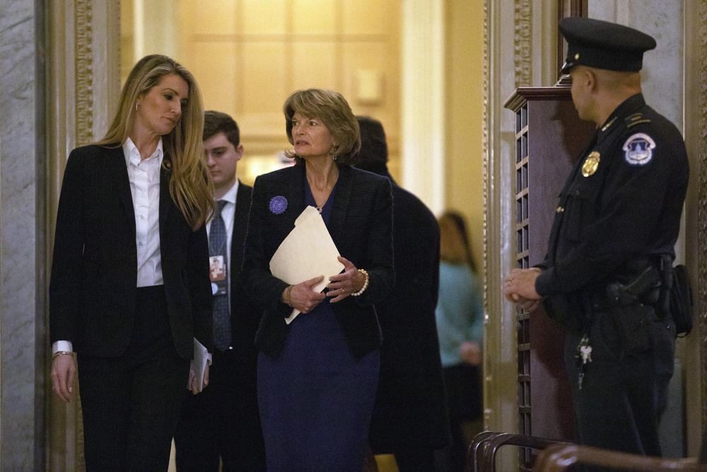 Sen. Kelly Loeffler, R-Ga., left, and Sen. Lisa Murkowski, R-Alaska, walk on Capitol Hill in Washington, Thursday, Jan. 30, 2020, as they return to the Senate chamber after a break in the impeachment trial of President Donald Trump.