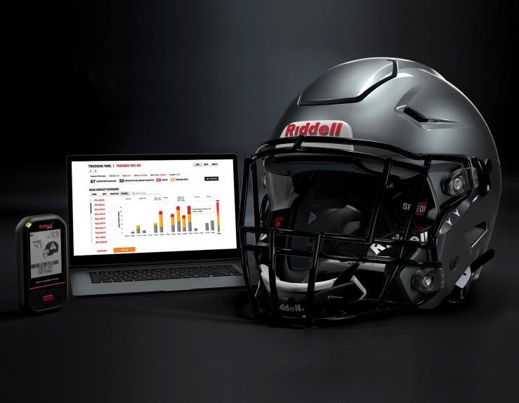 In this May 2020 photo provided by Riddell, a Riddell SpeedFlex helmet sits next to a computer screen displaying information from the InSite tool. 