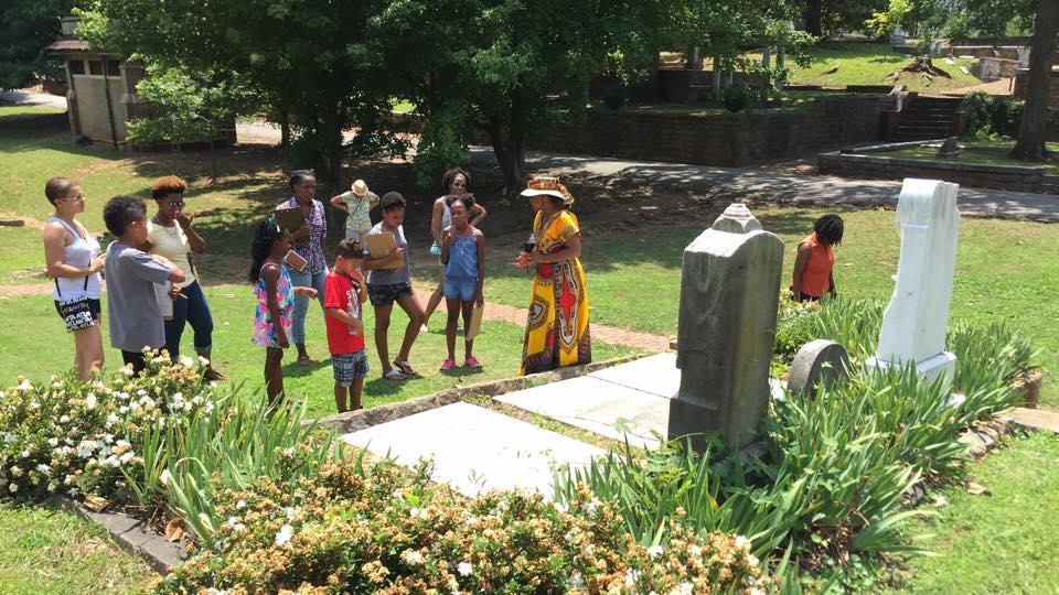 Genealogist and historian D. L. Henderson leads a tour of African American gravesites at Oakland Cemetery in Atlanta on June 11, 2016.