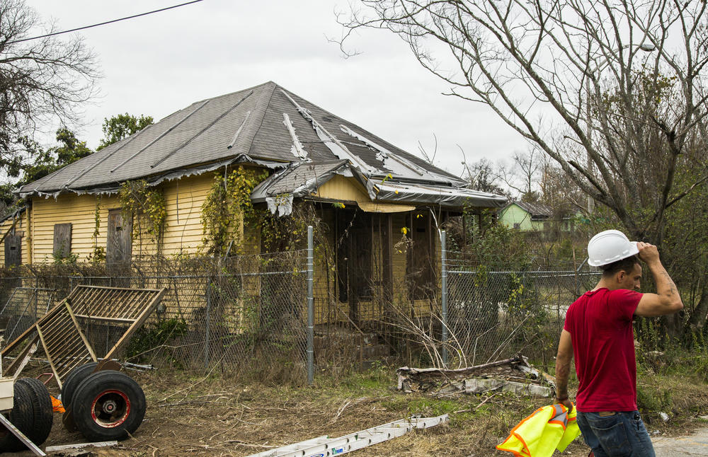 William Simpson ends his work day helping to prepare for moving the home next door to the childhood home of Little Richard, shown here, in Macon's Pleasant Hill Neighborhood Wednesday. 
