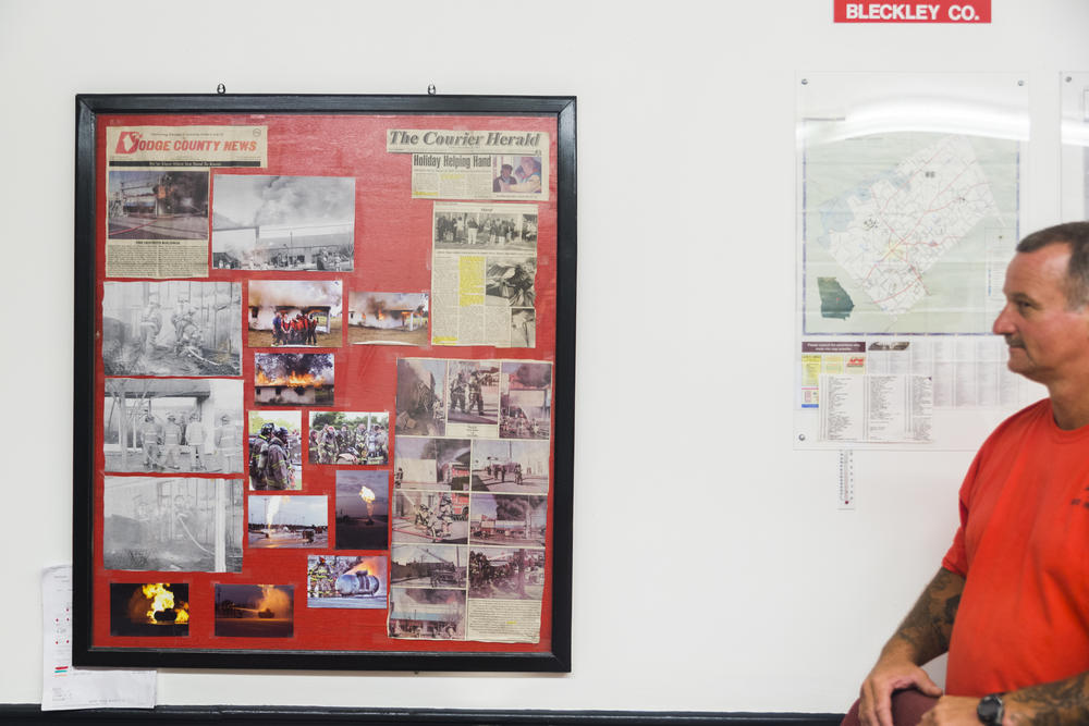 Dodge State Prison Firefighter David Foxworth with the bulletin board full of the department's news clippings, given pride of place in the fire hall. 