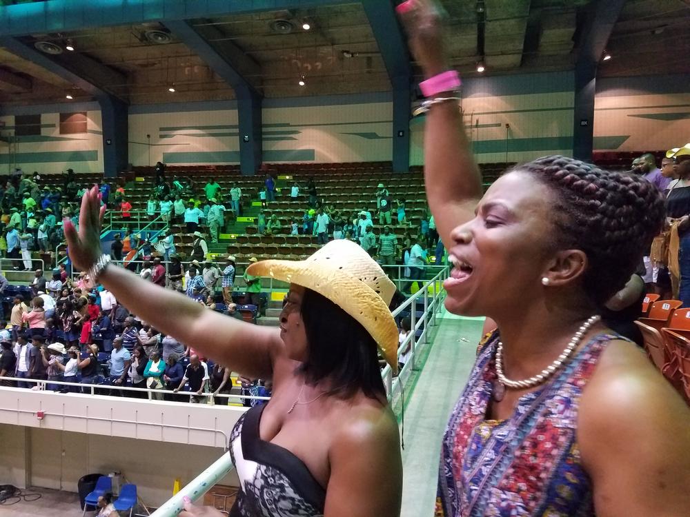 Reeshemah Johnson (left) and Ramona Famble cheer at the Southeastern Rodeo Association's July rodeo in Savannah, Ga., billed as the city's first black rodeo.