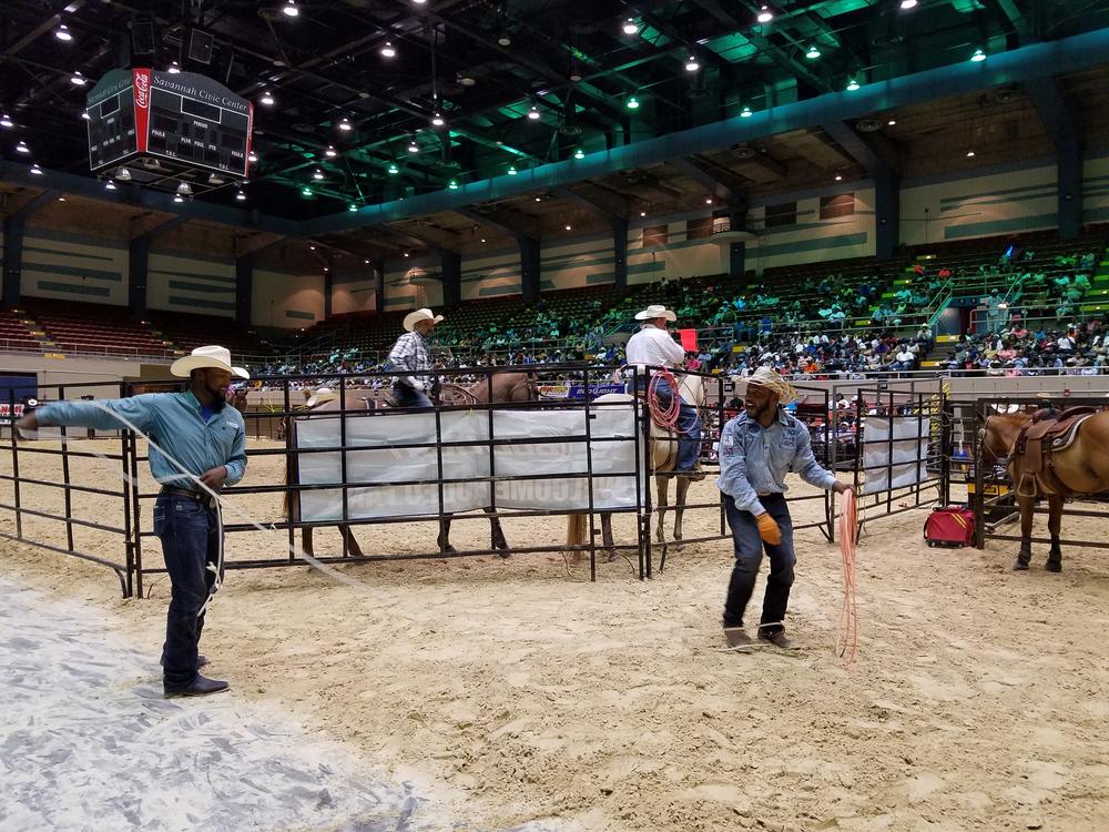 A pair of cowboys practice their roping skills - on each other